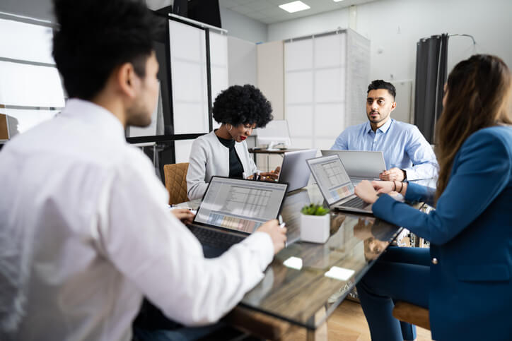 A payroll team processing salaries and benefits in an office setting