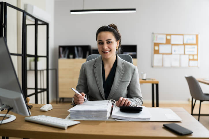 A certified payroll administrator training graduate preparing year-end documentation